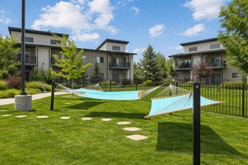 Shared lawn area with turquoise hammocks and walkway